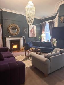 a living room with a couch and a fireplace at The Boho - 4 min walk to beach & town in Bournemouth