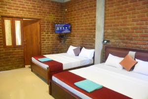 Letto o letti in una camera di Ciel Star Anuradhapura