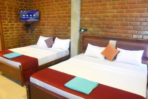 Letto o letti in una camera di Ciel Star Anuradhapura