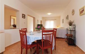 a dining room with a table and chairs at Holiday Home Put Vrljuge Iv in Sukošan