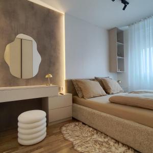 a bedroom with a bed and a mirror on the wall at Apartment Feel Banja Luka in Banja Luka +12 photos