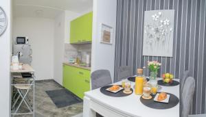 a kitchen with a table with food on it at Apartman Nika in Vukovar +18 photos
