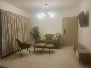 a living room with a couch and a table at Comfortable apartment in Los Mameyes