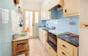 a kitchen with a sink and a stove top oven at Stunning Apartment In Santa Pola in Santa Pola