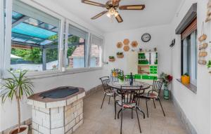 a patio with a table and chairs and a fireplace at Beautiful Home In Ledenice With Sauna in Ledenice
