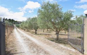 a dirt road with trees and a fence at Cozy Home In Monterosso Almo in Monterosso Almo +15 photos