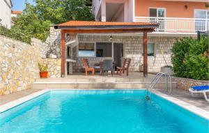 a swimming pool with a patio and a house at Holiday Home Imotski 04 in Imotski +29 photos