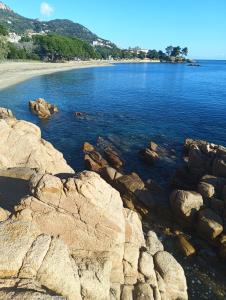 a view of a beach with rocks in the water at La GemMa in Santa Maria Navarrese