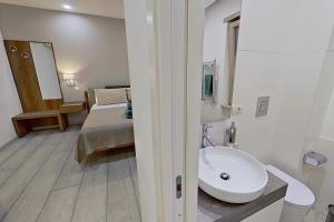 a bathroom with a sink and a bed in a room at Museo19 in Naples +32 photos
