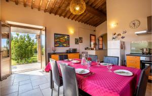 a dining room with a table with a red table cloth at Awesome Home In Volterra in Montaperti