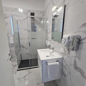 a white bathroom with a shower and a sink at Casa Riviera del Brenta in Mira