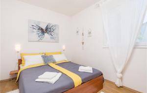 a bedroom with a bed with two towels on it at 2 Bedroom Lovely Apartment In Potocnica in Potocnica