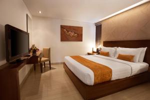 A bed or beds in a room at d'primahotel Seminyak