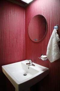 a bathroom with a white sink and a mirror at Birdsnest Hostel Hongdae Foreigner only in Seoul