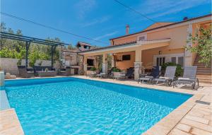 a swimming pool in front of a house at Beautiful Home In Brodarica With Wifi in Brodarica