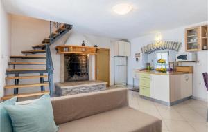 a living room with a couch and a kitchen with a fireplace at Four-Bedroom Holiday Home Labin With Sea View 08 in Labin