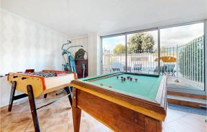 a living room with a pool table and a window at Lovely Home In Saint-Maurice-Sur-Eygu in Saint-Maurice-sur-Eygues