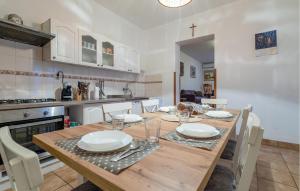 a dining room with a wooden table and a kitchen at Beautiful Home In Dalj With Wifi in Dalj