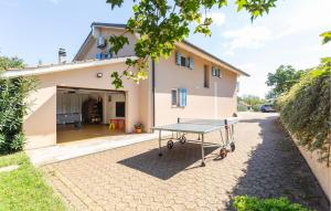 a ping pong table in front of a house at Holiday Home Pazin 07 in Pazin