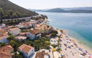 a view of a beach with people in the water at One-Bedroom Apartment In Klek in Klek