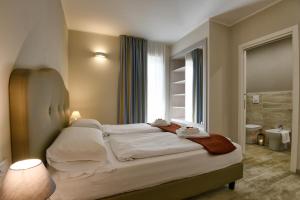 a bedroom with a large bed with a window at La Dolce Vita Relais - Hotel Gallo in Tignale +66 photos