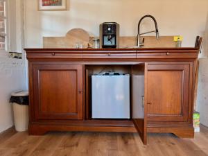 a kitchen counter with a sink and a refrigerator at La Forge Tranquille in Heudreville-sur-Eure
