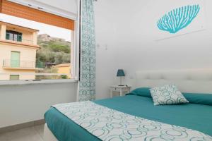 Posteľ alebo postele v izbe v ubytovaní B&B Marina House Porto Ercole