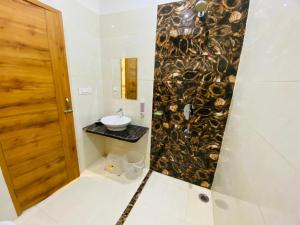 a bathroom with a sink and a mirror at RY Luxuries, 300m from Golden Temple in Amritsar +59 photos