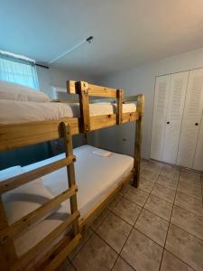 a bedroom with two bunk beds in a room at Boquerón Beach & Country Cabins in Boqueron