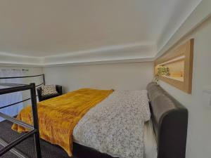 a small bedroom with a bed and a chair at The Buda Garden Condo B in Budapest