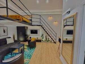 a living room with a couch and a staircase at The Buda Garden Condo B in Budapest