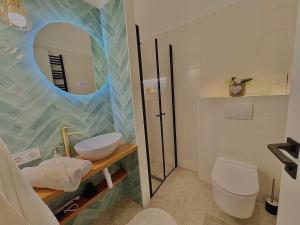 a bathroom with a sink and a toilet and a mirror at The Buda Garden Condo B in Budapest +17 photos