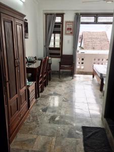 a living room with a table and a bedroom at Gray Stone homestay in Hoi An