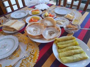 a table with plates of food and bread on it at Gastfamilie Ella in Ella +32 photos