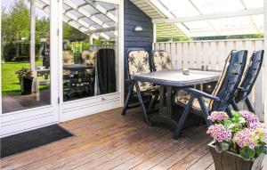 a patio with a table and chairs on a deck at Holiday Home Lillevangsvej in Jægerspris