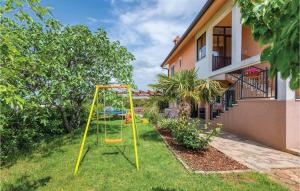 a playground in a yard next to a house at 1 Bedroom Stunning Apartment In Kastel in Kaštel