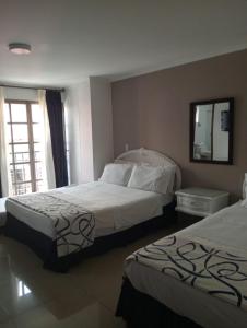 Postel nebo postele na pokoji v ubytování Hotel Suite Santa Rosa