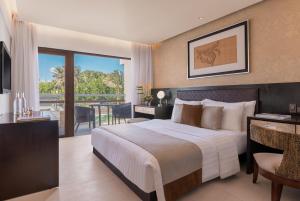 a bedroom with a large bed and a balcony at The District Boracay in Boracay