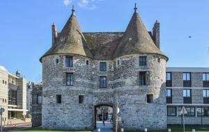 an old stone building with an arch entrance at Les Embruns in Neuville-lès-Dieppe