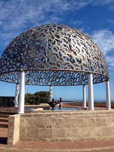 a statue of a man sitting under an umbrella at Hospitality Geraldton, SureStay by Best Western in Geraldton