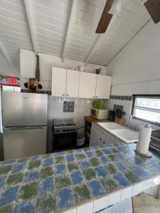 a kitchen with white cabinets and a counter top at Boquerón Beach & Country Cabins in Boqueron
