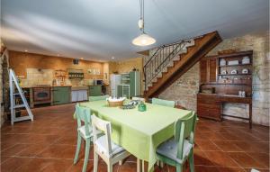 a kitchen and dining room with a table and chairs at Holiday Home Butkovici Croatia in Butkovići