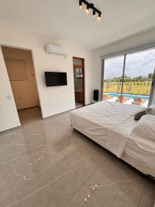 a bedroom with a large bed and a television at Casa Borges in Paraná