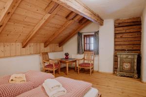 a room with two beds and a table and a stove at SCHENE Kammer in Abtenau
