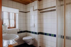 a bathroom with a toilet and a sink and a tub at SCHENE Kammer in Abtenau +67 photos