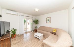 a living room with a couch and a tv at Amazing Apartment In Kastel Stari in Kastel Stari