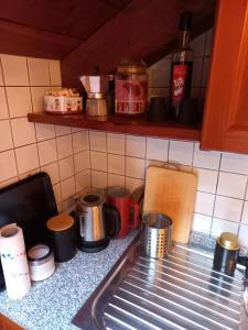 a kitchen counter with pots and pans on a counter top at Mansarda Bardonecchia in Bardonecchia +15 photos