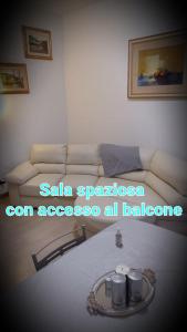a living room with a couch and a table at Appartamento Stadio free bike in Bologna