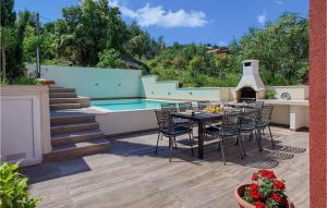 a patio with a table and chairs and a pool at Villa Karmen Adriatica in Zadar +31 photos