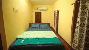 a bedroom with a bed in a room with a curtain at Blue Eye Coastal House, Beach House in Kaup